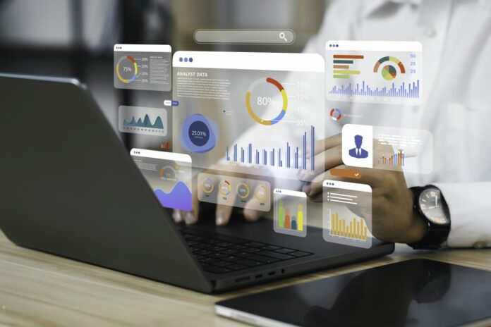 An analyst employing a computer and dashboard for comprehensive data business analysis and Data Management System with KPIs and metrics linked to the database for technology finance, operations, sales, and marketing